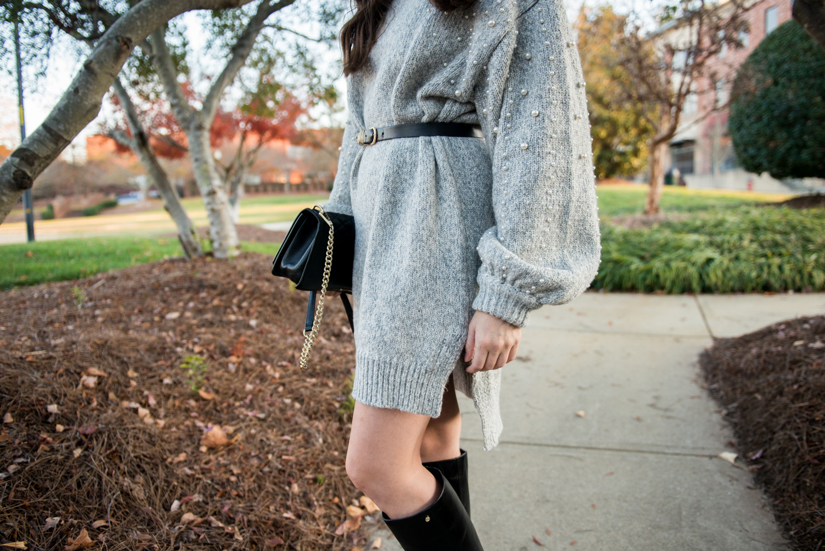 oversized pearl sweater dress and black waist belt 